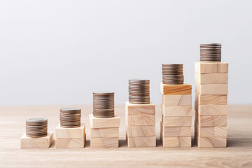 Wooden Blocks Forming Steps with Coins for Financial Growth Concept
