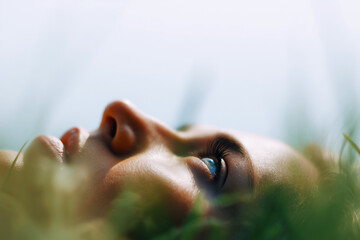 Person Lying on Grass with a Focused Gaze Towards the Sky