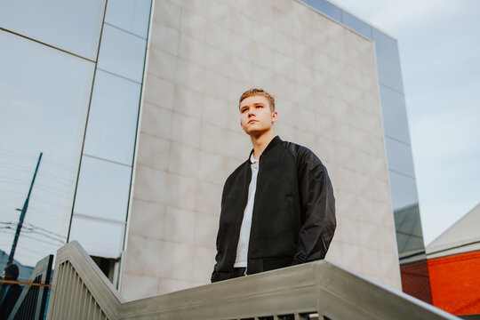Student standing seriously in modern school yard outdoors