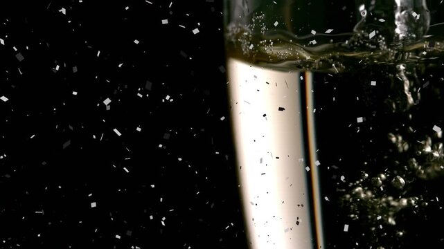 Animation of confetti over glass of champagne