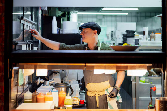 Chef preparing orders in a professional restaurant kitchen