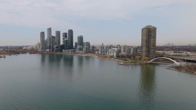 Drone Flyover Of Humber Bay And Parklawn Skyline On Lake Ontario In Etobicoke, Toronto, Canada.
