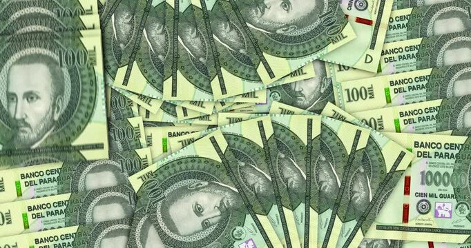 Paraguay guarani Paraguayan money banknotes in a cash fan mosaic pattern loop. 100000 PYG notes. Abstract concept of bank, finance, economy seamless and looped design background.