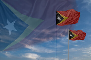 Card for Independence day National flags of East Timor waving in sky