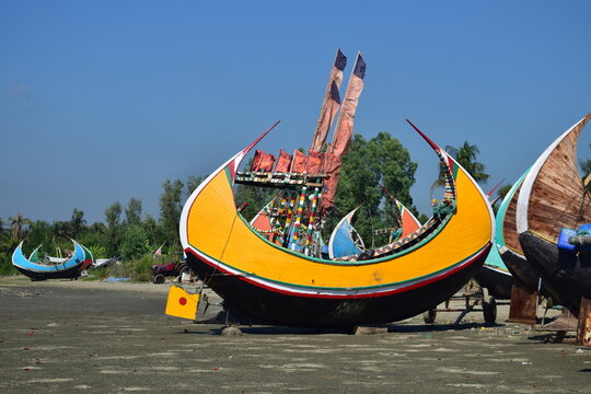 Sampan Boat on the Beach - Coastal Simplicity and Tradition. A traditional sampan boat rests quietly on the beach, reflecting the timeless bond between coastal life and the sea.