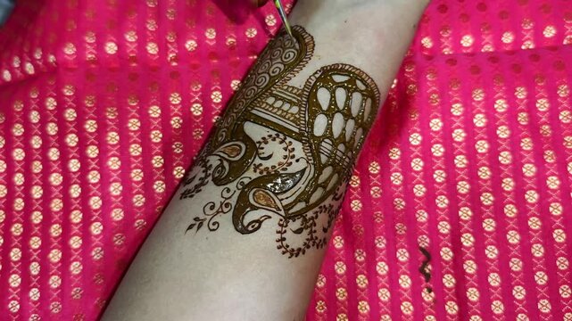 Mehndi artist making mehndi bridal hand In India, mehndi design.