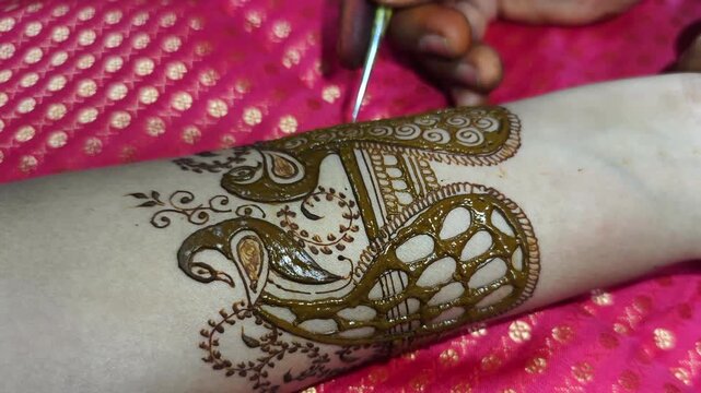 Mehndi artist making mehndi bridal hand In India, mehndi design.