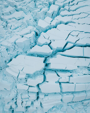 Aerial view of jagged ice formations create a stark, geometric landscape under the Antarctic sky, Paradise Bay, Antarctica.