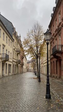 Cobblestone Street with Historic Buildings Under Cloudy Sky in Weimar Germany