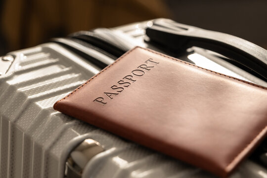 Closed  suitcase with passport, travel documents and luggage ready for departure