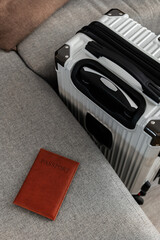 Closed  suitcase with passport, travel documents and luggage ready for departure