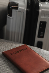 Closed  suitcase with passport, travel documents and luggage ready for departure