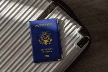 United States passport  and modern suitcase, travel preparation still life with luggage and international journey concept