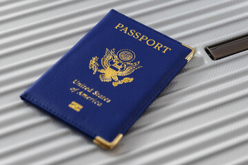 United States passport  and modern suitcase, travel preparation still life with luggage and international journey concept