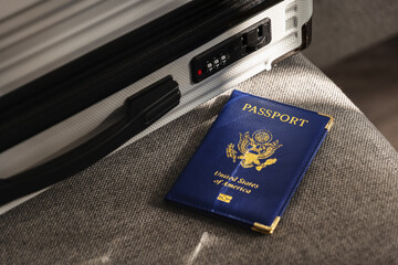 United States passport  and modern suitcase, travel preparation still life with luggage and international journey concept