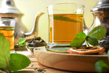 Green tea on a wooden table with ingredients elevated view