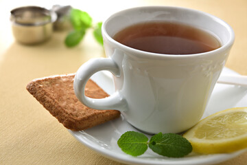 Detail of white ceramic teacup and plate with ingredients