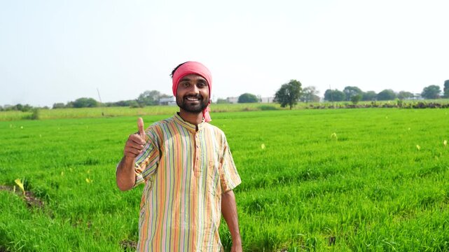indian farmer showing thumps up at agriculture field 