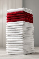 stack of white towels with red ones in between visualising the concept of menstruation cycle period