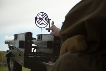 Machine gunner adjusts his weapon. A machine gun sight. Air defense in combat operations.