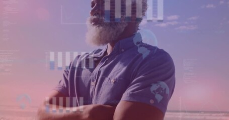 senior man standing on beach at sunset, displaying floating bar charts and globe icons for finance - Powered by Adobe