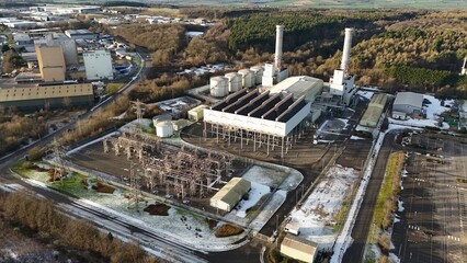 Aerial view of the Corby power plant standing stark against the landscape with its towering chimneys and complex infrastructure, Corby, Corby, United Kingdom.