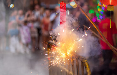 Traditional chinese firecrackers are exploding with flashes and smoke in Lunar new year.