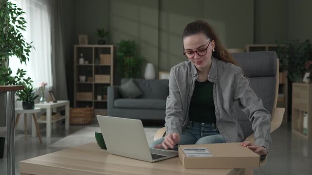 Happy woman receiving parcel and leaving positive online review