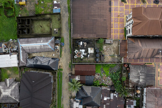 Aerial view of rooftops and compounds displaying a stark contrast between aged structures and newer constructions, Bonny Kingdom, Rivers, Nigeria.