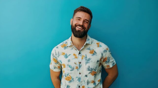 A cheerful individual in a brightly colored patterned shirt posing for the camera.