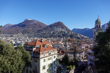 Fototapeta premium A sweeping view of Lugano, Switzerland, where the city, lake, and surrounding mountains come together in perfect harmony.