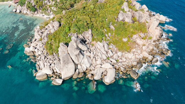 Aerial view of striking granite boulders meet lush tropical foliage, fringed by turquoise waters, a tranquil paradise beckons, Ko Tao, Surat Thani, Thailand.