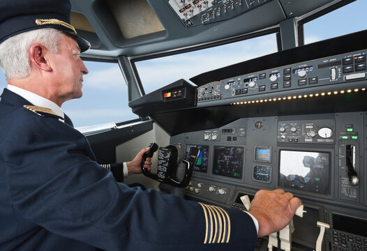 Pilot operating airplane cockpit controls in Bavaria Studio Munich