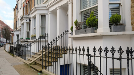 Typical Victorian terraced houses in England. Exterior view of cozy residential buildings in London...
