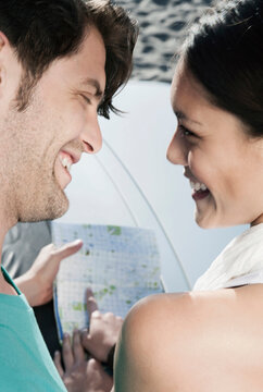 Smiling couple planning holiday with map outdoors in Majorca Spain