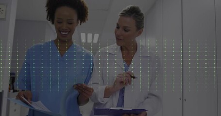 Animation of heart rate monitor over diverse female doctor and healthworker discussing at hospital - Powered by Adobe