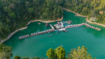Aerial view of the tranquil turquoise waters embracing the floating bungalows of Khao Sok National Park, a haven of serenity amidst lush greenery, Khao Sok National Park, Surat Thani, Thailand.