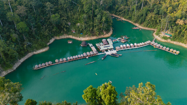 Aerial view of the tranquil turquoise waters embracing the floating bungalows of Khao Sok National Park, a haven of serenity amidst lush greenery, Khao Sok National Park, Surat Thani, Thailand.
