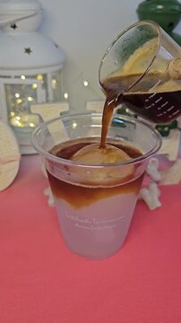 Aesthetic Iced Coffee Pour: The artful cascade of dark espresso is gracefully poured over a sphere of ice cream, creating a symphony of flavors and textures in the glass.