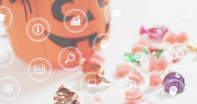 Wide shot initiating icons floating over pumpkin bucket and candies, camera moving focusing spider