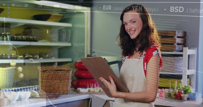 Cafe worker holding clipboard checking stock FX and graph moving across causing glancing up smiling