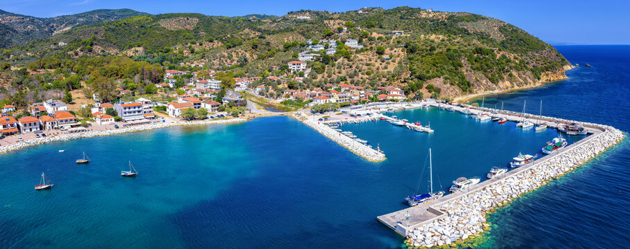 Panoramic aerial view of the traditional fishing village Platanias, South Pelion, Greece, with marina and waterfront promenade