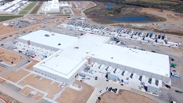 Aerial rising shot, Meta data center, revealing large technology campus and modern digital infrastructure supporting cloud computing and global connectivity