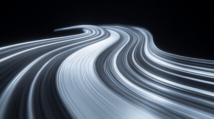 Abstract long exposure shot of winding road in blue and white light trails, set against black