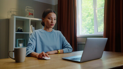 Asian woman worker remote hard work laptop home. Korean girl type keyboard. Female employee surfing net. Busy serious ceo person use pc. Online education. Computer freelance. Distant searching job.