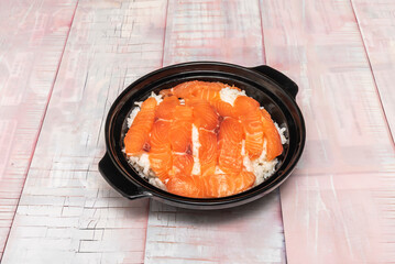Plate with the three elements separated: a portion of rice, a portion of salmon pieces, and a selection of assorted sushi to mix and match as desired