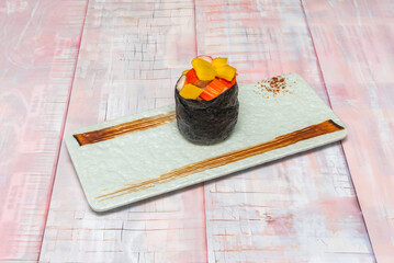 A close-up of several gunkan, showing the texture and color of the fish roe or other elements that crown the small portion of rice.