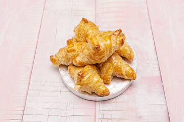 An image of a wholemeal or rye croissant, with a deeper, earthier color, split open to reveal a dense yet fluffy crumb, accompanied by cream cheese