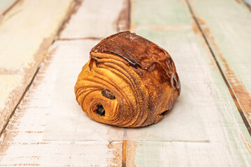  An image of two pains au chocolat on matching breakfast plates, with coffee and orange juice, evoking a peaceful morning filled with small pleasures