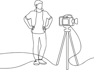 person standing next to video camera on tripod